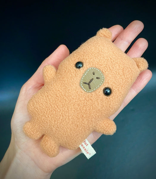 Mini Baby Capybara plush on hand.