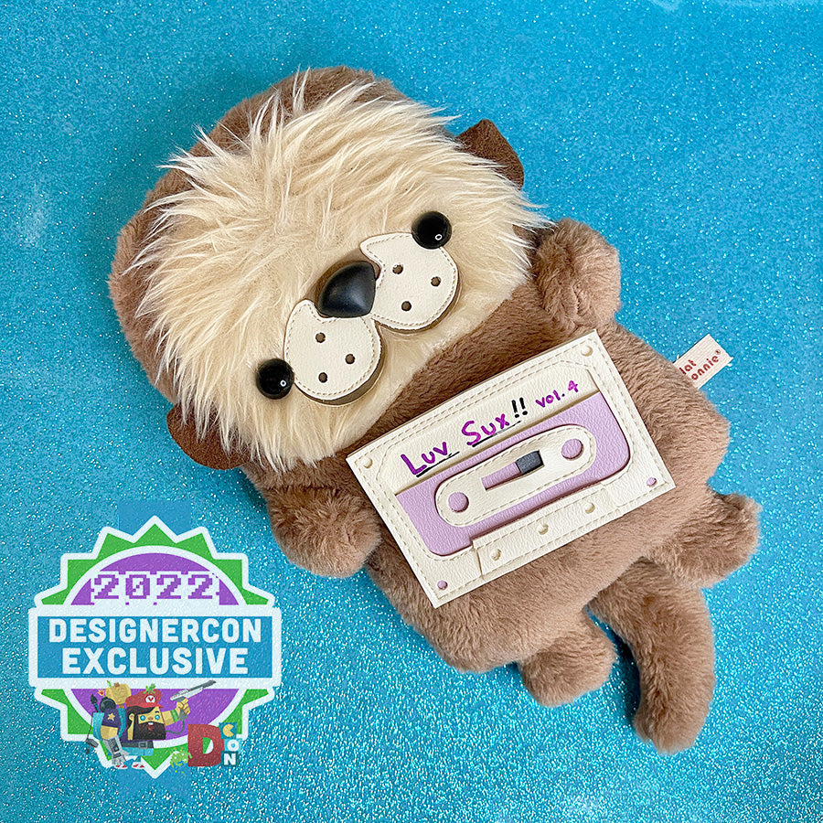 Cute otter plush with a "Luv Sux" mix tape accessory.